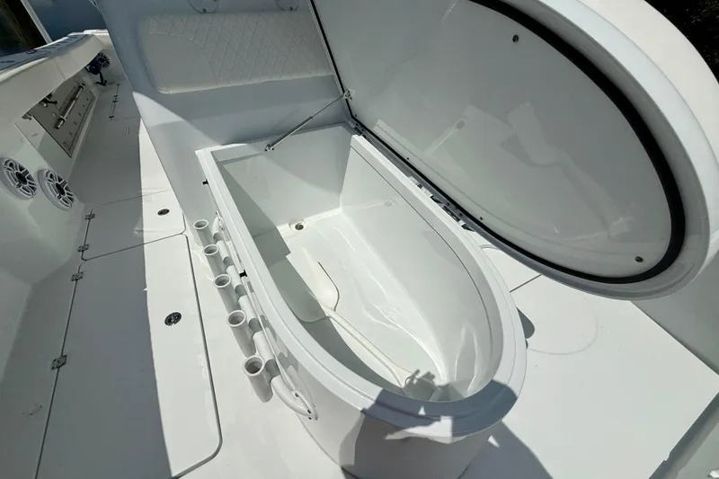 Slide: The Image of 2023 Freeman 34VH boat interior with open storage compartment and rod holders. - 28