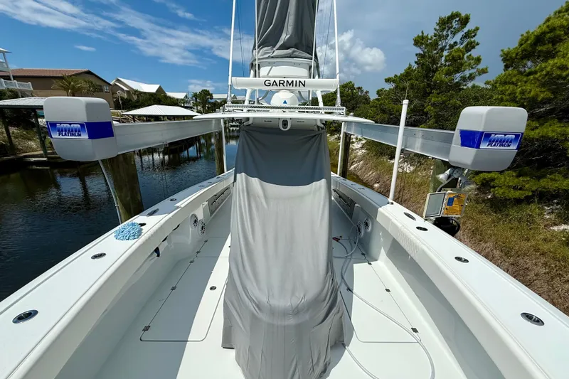 Slide: The Image of 2023 Freeman 34VH boat with Garmin equipment, docked near lush greenery. - 6