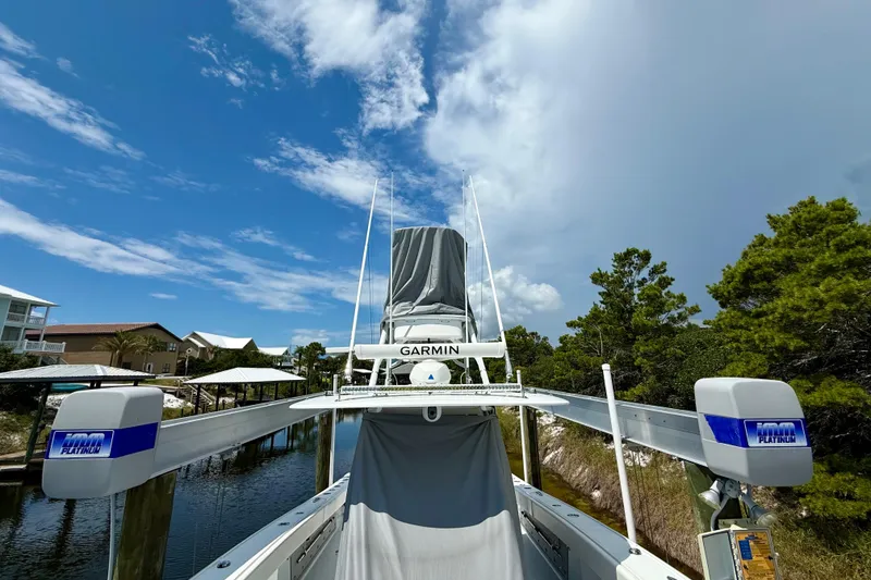 Slide: The Image of 2023 Freeman 34VH boat docked under a clear blue sky with Garmin equipment. - 7