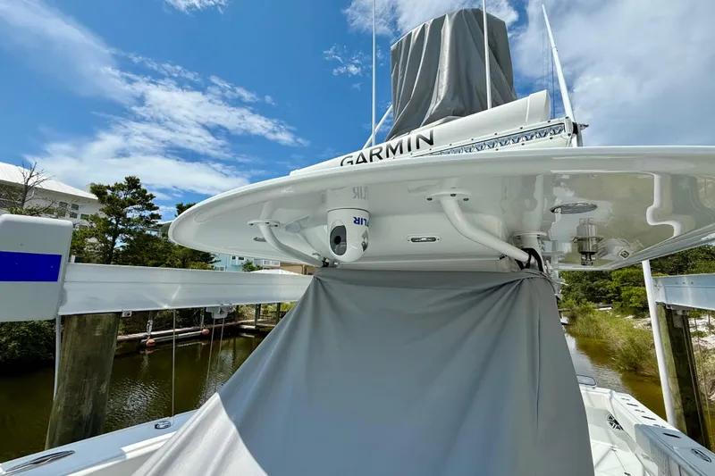 Slide: The Image of 2023 Freeman 34VH boat with Garmin equipment, docked under a clear blue sky. - 8