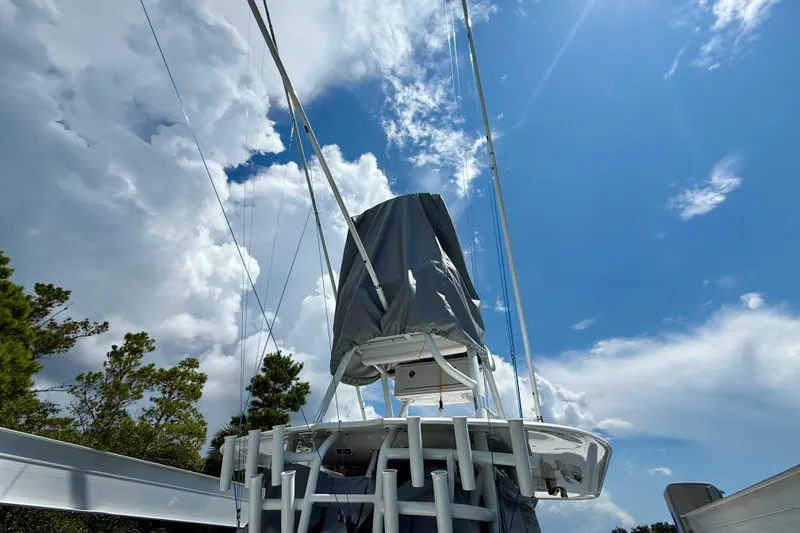 Slide: The Image of 2023 Freeman 34VH boat under a cloudy sky with trees in the background. - 9