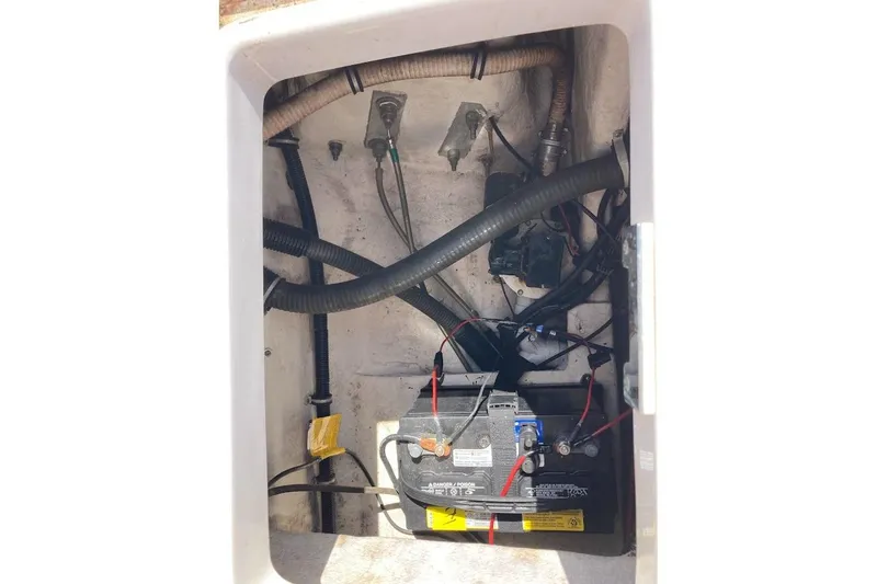 Slide: The Image of 2005 Donzi 35 ZF Daytona boat battery compartment with wiring and hoses. - 43