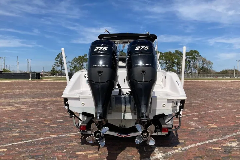 Slide: The Image of 2005 Donzi 35 ZF Daytona with twin 275 horsepower outboard engines, parked on brick pavement. - 6