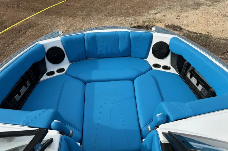 Slide: The Image of 2022 Malibu Wakesetter 23 MXZ boat with blue seating and integrated speakers. - 10