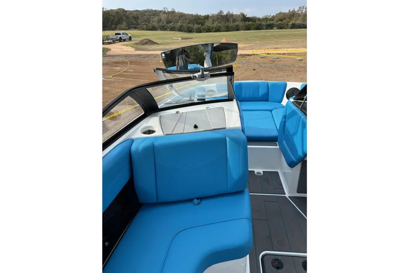 Slide: The Image of 2022 Malibu Wakesetter 23 MXZ interior with blue seating and sleek design. - 12
