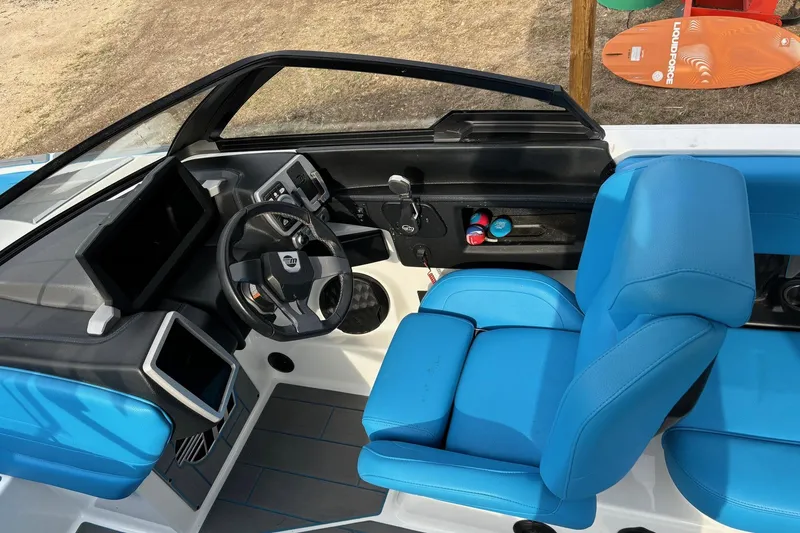 Slide: The Image of 2022 Malibu Wakesetter 23 MXZ interior with blue seats and modern dashboard. - 14
