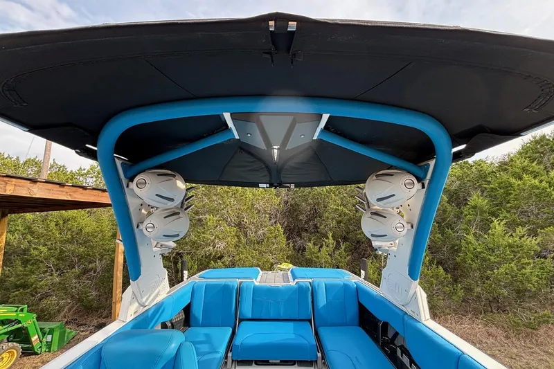 Slide: The Image of 2022 Malibu Wakesetter 23 MXZ interior with blue seating and overhead speakers. - 17