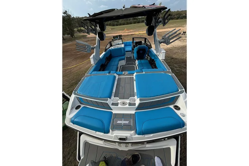 Slide: The Image of 2022 Malibu Wakesetter 23 MXZ boat with blue seating and sleek design. - 18