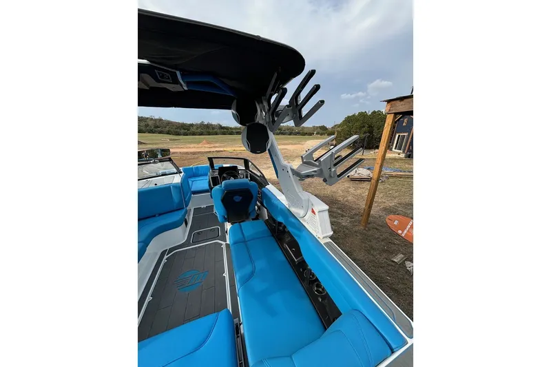 Slide: The Image of 2022 Malibu Wakesetter 23 MXZ boat with blue seating and wakeboard racks. - 19
