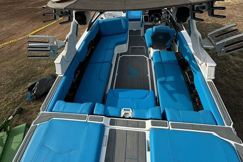 Slide: The Image of 2022 Malibu Wakesetter 23 MXZ boat interior with blue seating and sleek design. - 20