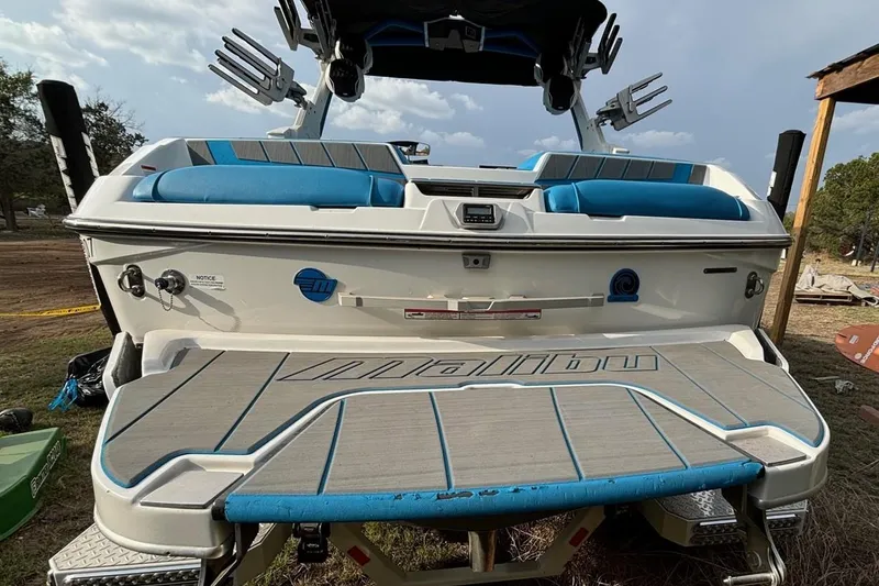 Slide: The Image of 2022 Malibu Wakesetter 23 MXZ boat with blue seating and sleek design. - 22