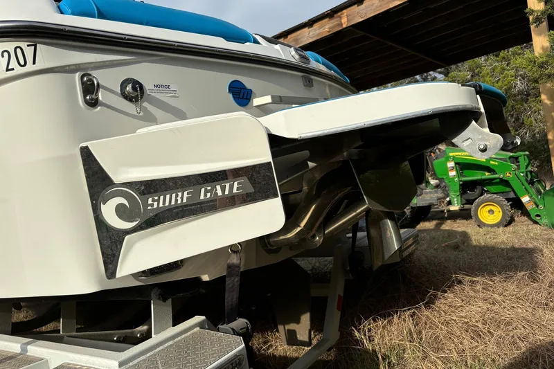 Slide: The Image of 2022 Malibu Wakesetter 23 MXZ with Surf Gate feature, parked outdoors. - 23