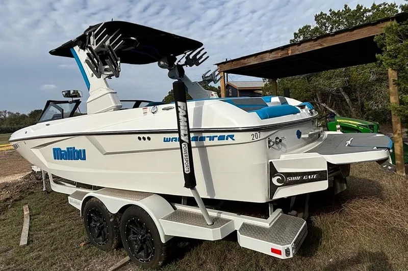 Slide: The Image of 2022 Malibu Wakesetter 23 MXZ boat on trailer, featuring sleek design and surf gate technology. - 3