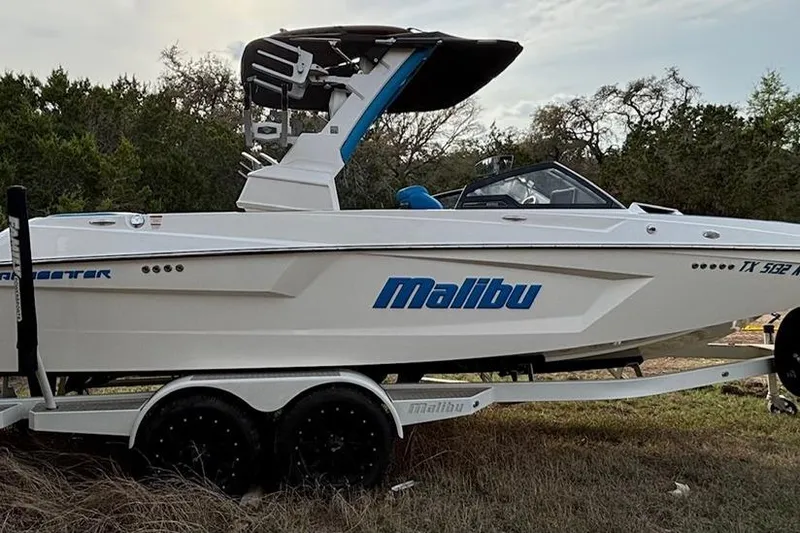 Slide: The Image of 2022 Malibu Wakesetter 23 MXZ boat on trailer, parked outdoors. - 4