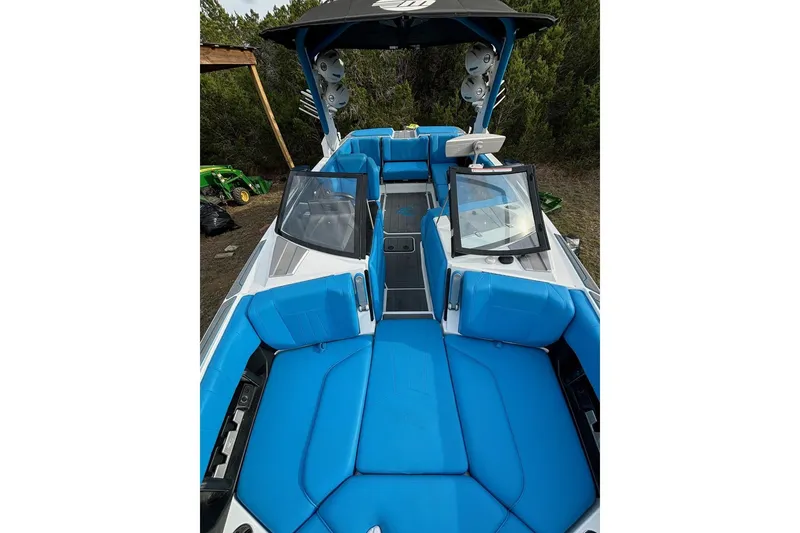 Slide: The Image of 2022 Malibu Wakesetter 23 MXZ boat with blue seating and sleek design. - 9