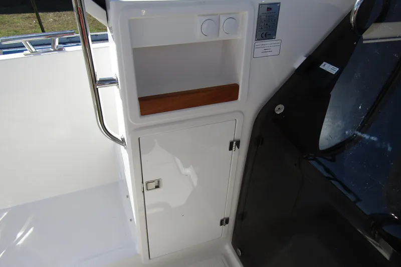 Slide: The Image of Interior view of 2025 Nimbus Tender 9 boat, featuring storage compartment and sleek design. - 26