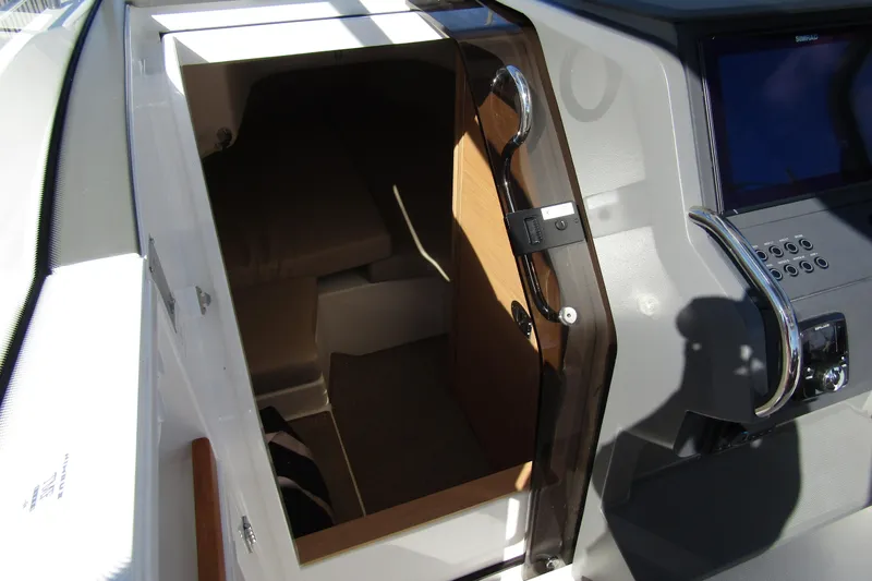 Slide: The Image of Interior cabin view of 2025 Nimbus Tender 9 boat, featuring modern design and controls. - 28