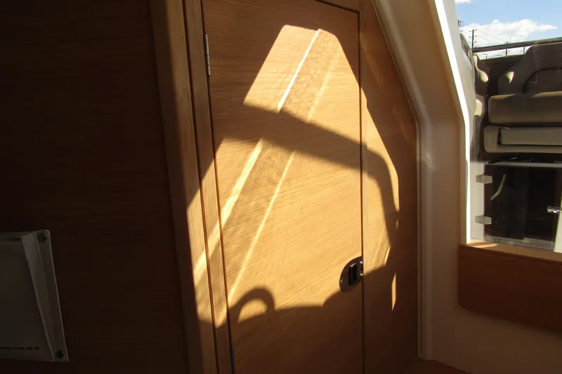 Slide: The Image of Interior of 2025 Nimbus Tender 9, featuring wooden door and sunlight casting shadows. - 31