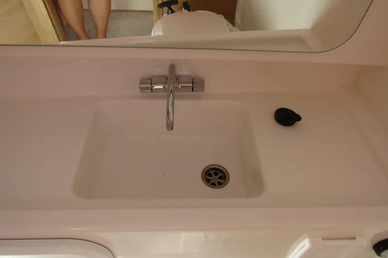 Slide: The Image of Sink area in 2025 Nimbus Tender 9 boat, featuring a modern faucet and drain. - 33
