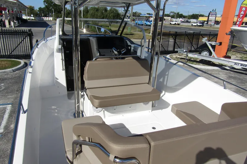 Slide: The Image of 2025 Nimbus Tender 9 boat interior with beige seating and modern dashboard. - 51