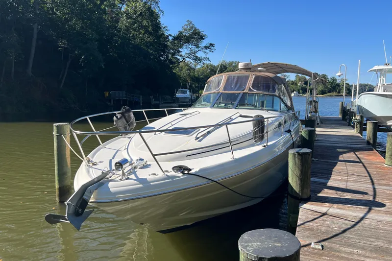 The Image of 2002 Sea Ray 360 Sundancer docked in a serene marina setting. - 0