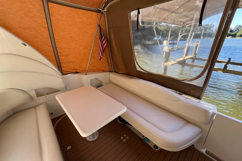 Slide: The Image of 2002 Sea Ray 360 Sundancer Aft Seating with Removable table and Faux Teak SeaDek in the Cockpit looking aft - 2