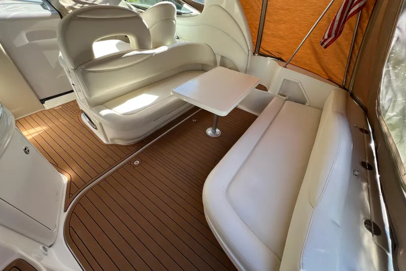 Slide: The Image of 2002 Sea Ray 360 Sundancer Aft Seating with Removable table and Faux Teak SeaDek in the Cockpit looking forward - 3