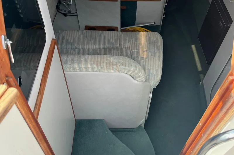 Slide: The Image of Interior view of 1991 Sea Ray 270 Sundancer boat with seating and carpeted floor. - 13
