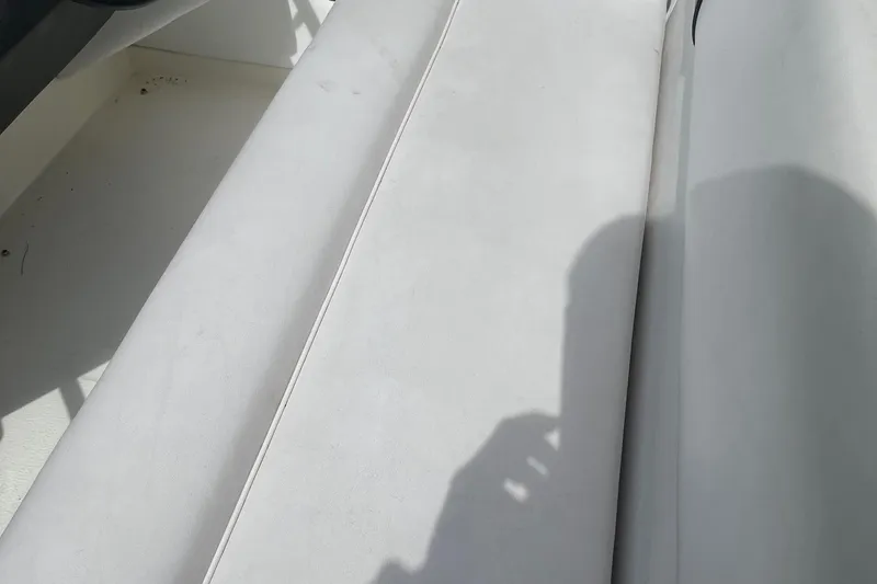 Slide: The Image of White seating on a 1991 Sea Ray 270 Sundancer boat, with shadow and sunlight. - 14