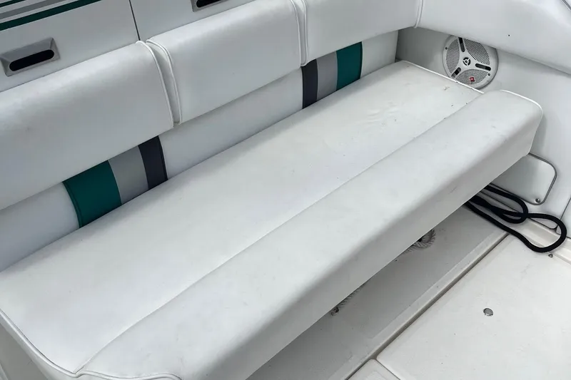 Slide: The Image of White seating area on a 1991 Sea Ray 270 Sundancer boat interior. - 18