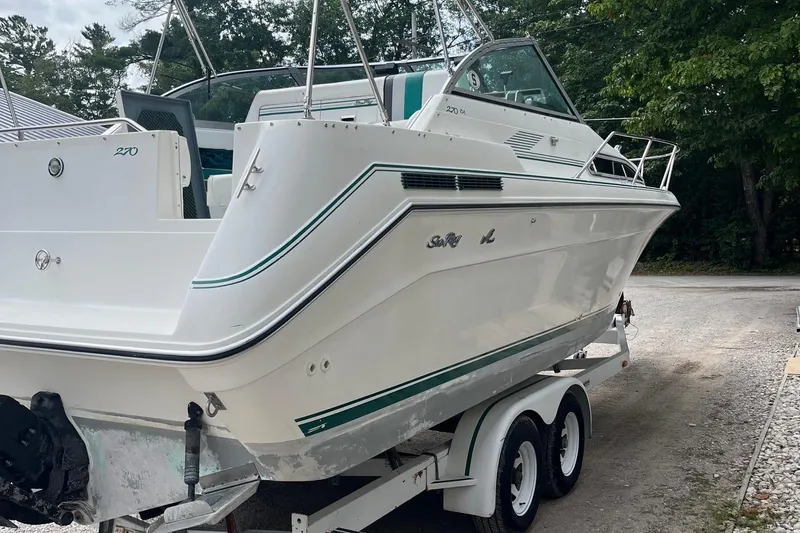 Slide: The Image of 1991 Sea Ray 270 Sundancer boat on trailer, parked outdoors, side view. - 21