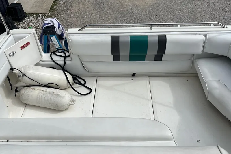 Slide: The Image of 1991 Sea Ray 270 Sundancer boat interior with white seating and fenders. - 3