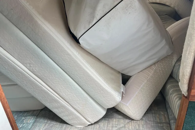 Slide: The Image of Interior of 1991 Sea Ray 270 Sundancer with stacked white cushions. - 9