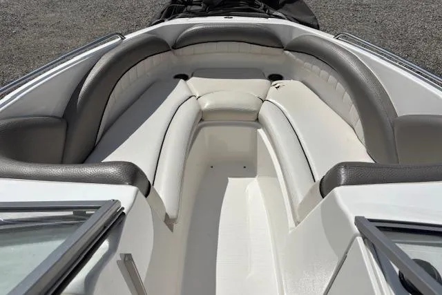 Slide: The Image of 2007 Yamaha AR 230 boat interior with cushioned seating and sleek design. - 10