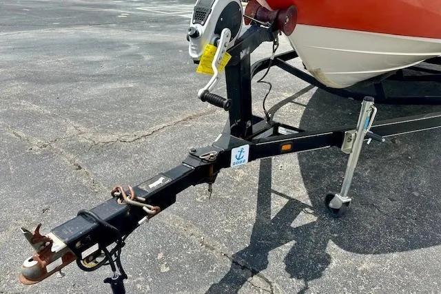 Slide: The Image of 2007 Yamaha AR 230 boat trailer hitch on asphalt, featuring a red and white hull. - 12