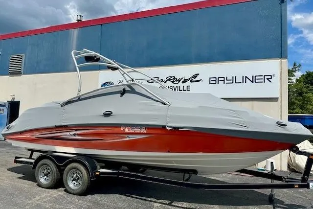 Slide: The Image of 2007 Yamaha AR 230 boat on trailer, covered, parked outside dealership. - 4