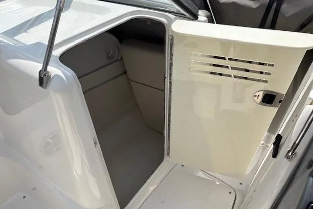 Slide: The Image of 2007 Yamaha AR 230 boat interior cabin with open door, showing seating area. - 8