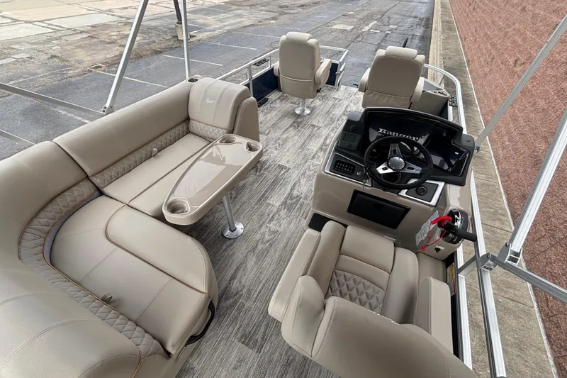Slide: The Image of 2025 Ranger 220F boat interior with beige seating and modern steering console. - 3