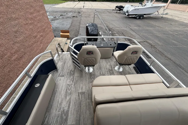 Slide: The Image of 2025 Ranger 220F boat interior with beige seating and modern design. - 7