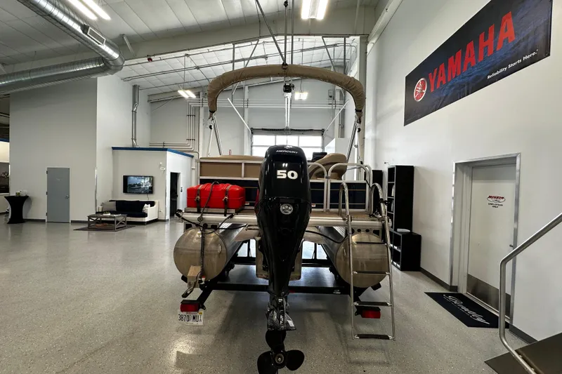 Slide: The Image of 2023 Sun Tracker Bass Buggy 16 XL Select pontoon boat in showroom with Yamaha banner. - 3