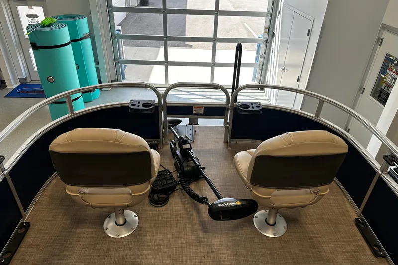 Slide: The Image of 2023 Sun Tracker Bass Buggy 16 XL Select interior with two seats and a trolling motor. - 7