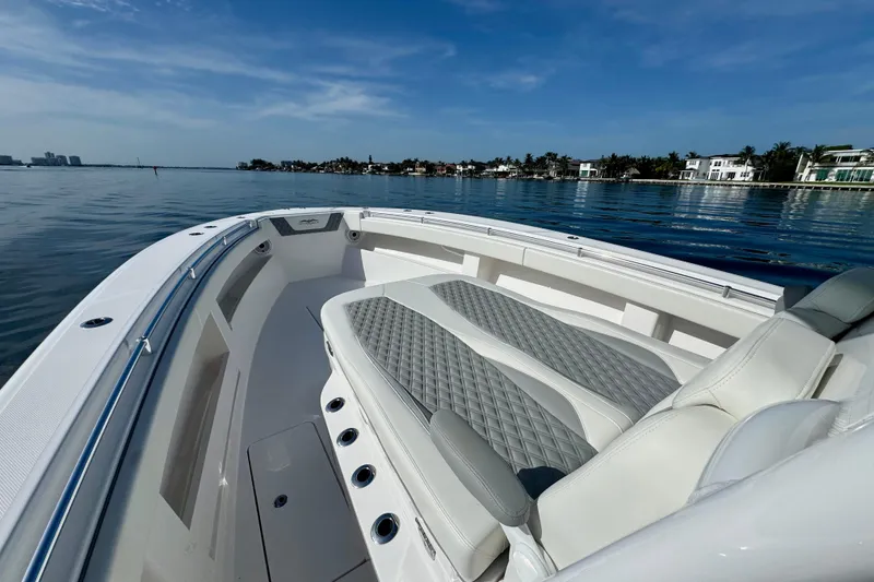 Slide: The Image of 2024 Invincible 39 Open Fisherman boat on calm waters, luxury seating, clear sky. - 10