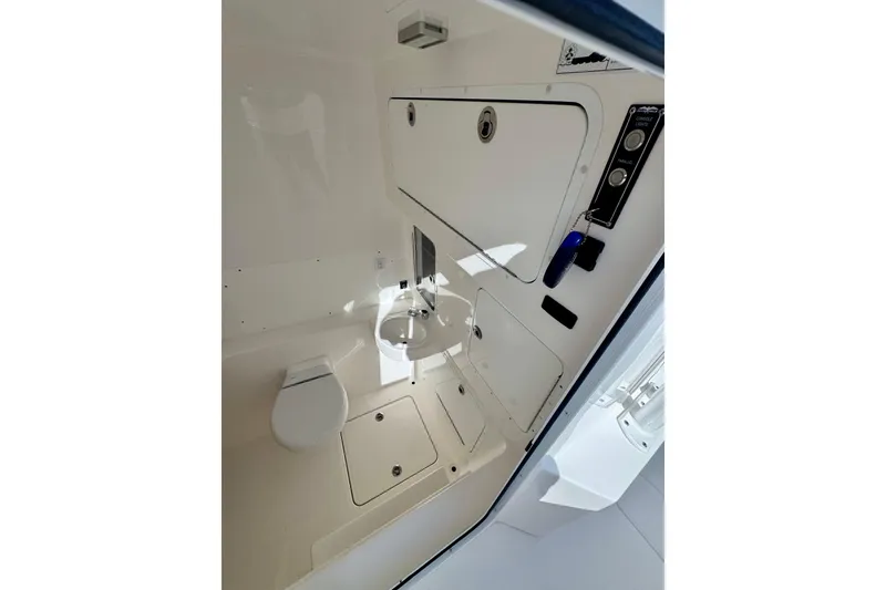 Slide: The Image of 2024 Invincible 39 Open Fisherman boat interior with toilet and sink. - 13