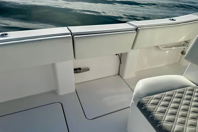 Slide: The Image of 2024 Invincible 39 Open Fisherman boat interior with cushioned seating and sleek design. - 16