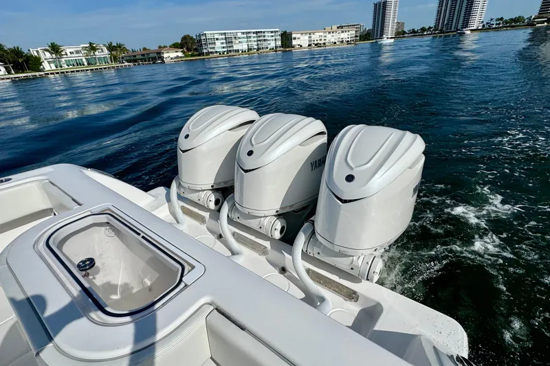 Slide: The Image of 2024 Invincible 39 Open Fisherman with triple Yamaha outboard engines on the water. - 18