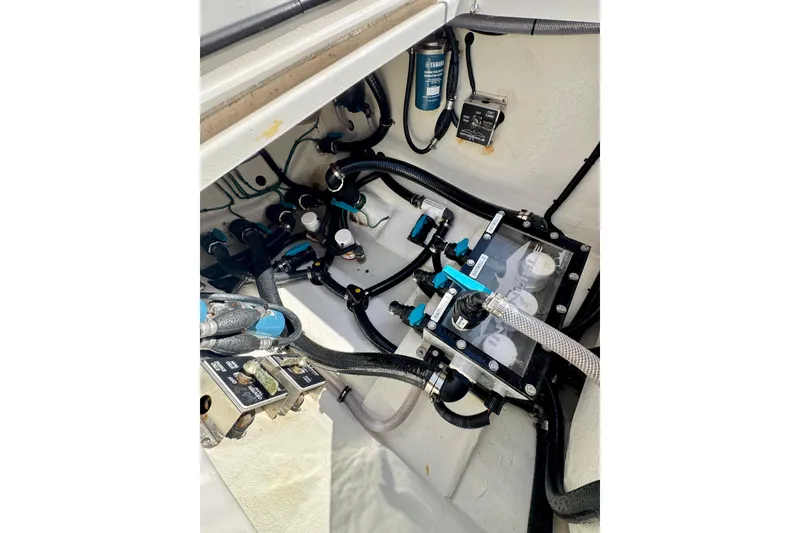 Slide: The Image of 2024 Invincible 39 Open Fisherman boat engine compartment with hoses and components. - 19