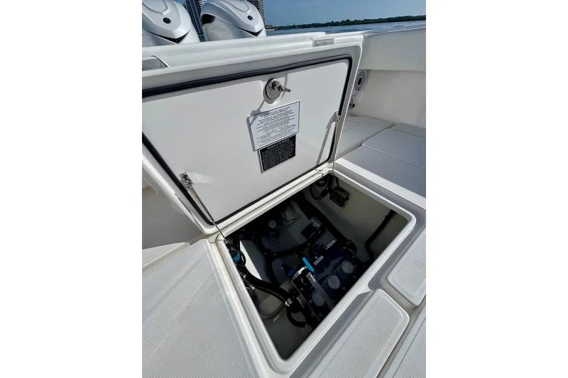Slide: The Image of 2024 Invincible 39 Open Fisherman boat hatch open, revealing internal components. - 20