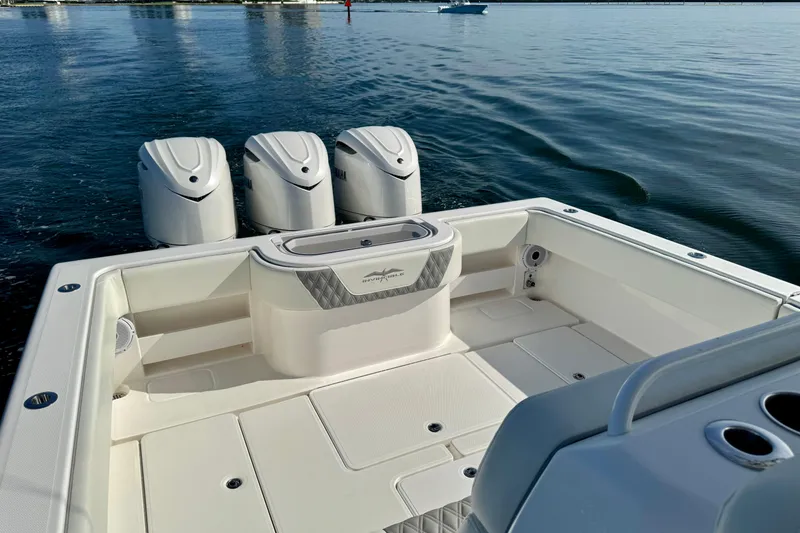 Slide: The Image of 2024 Invincible 39 Open Fisherman boat with triple outboard engines on calm water. - 22