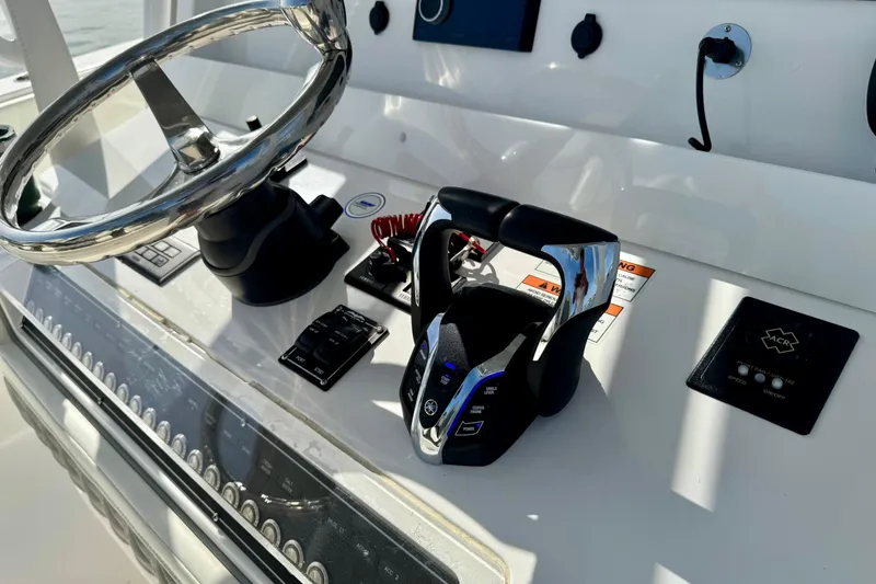 Slide: The Image of 2024 Invincible 39 Open Fisherman helm with steering wheel and controls. - 3