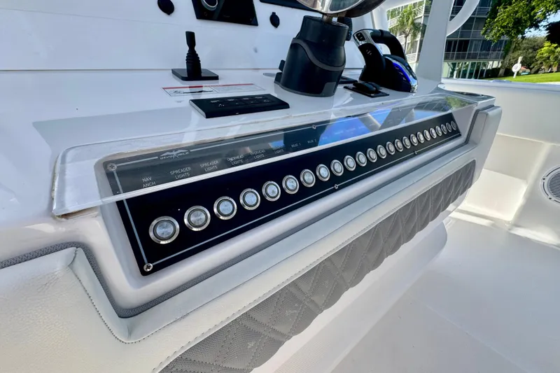 Slide: The Image of 2024 Invincible 39 Open Fisherman control panel with modern navigation and lighting switches. - 4